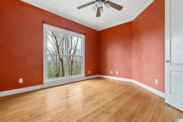 unfurnished room featuring crown molding, light hardwood / wood-style flooring, and ceiling fan