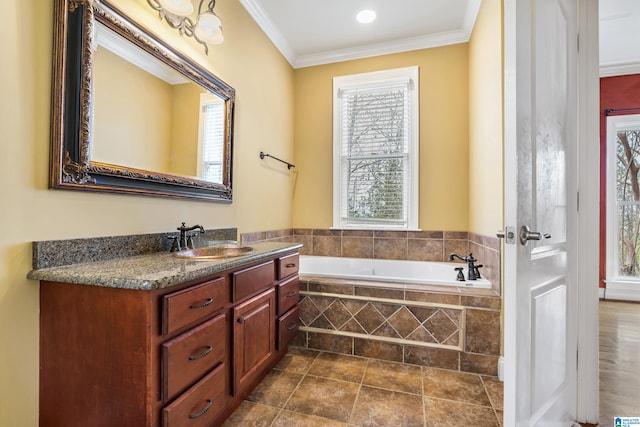 bathroom featuring a relaxing tiled tub, ornamental molding, and vanity