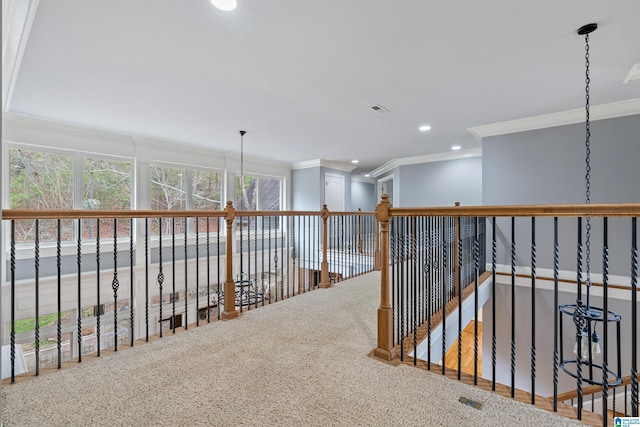 corridor with ornamental molding and carpet flooring