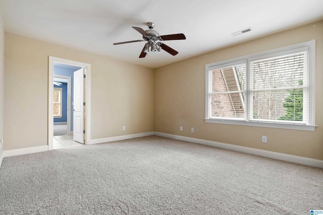 unfurnished room with light carpet and ceiling fan