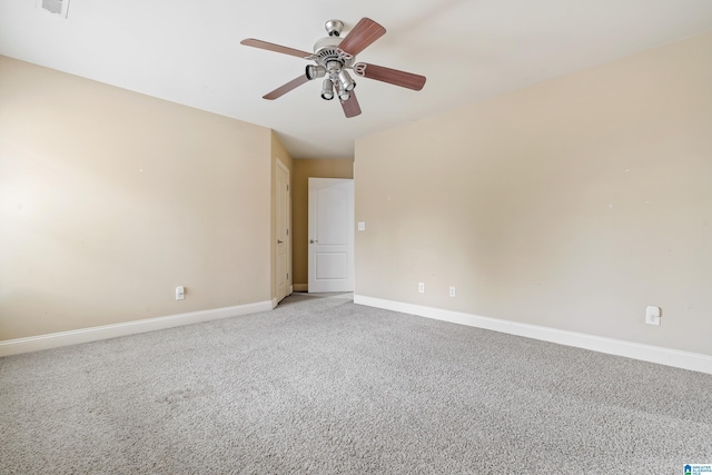 empty room with ceiling fan and light carpet