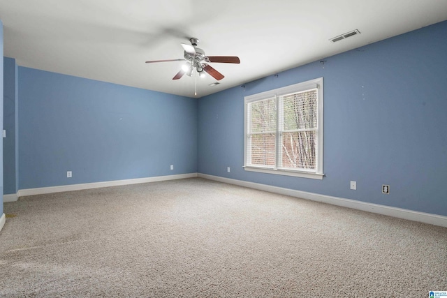 unfurnished room featuring ceiling fan and carpet