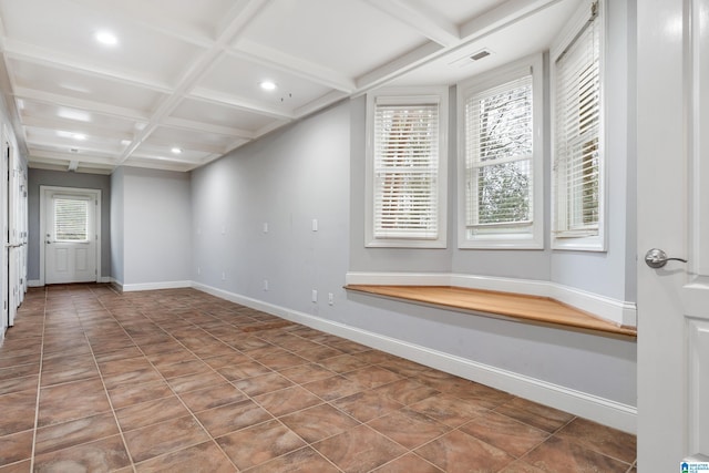 tiled spare room with beamed ceiling and coffered ceiling