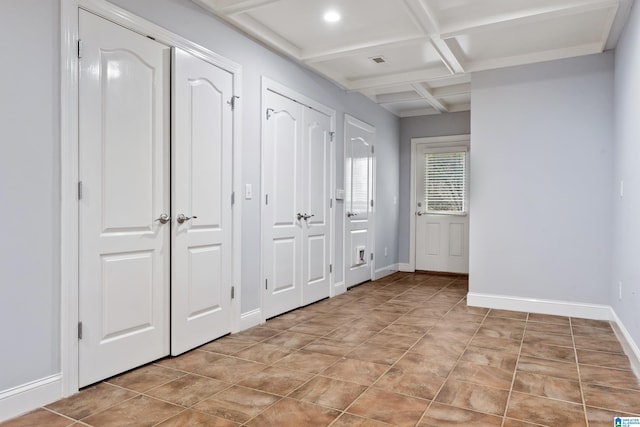 interior space featuring coffered ceiling and beamed ceiling