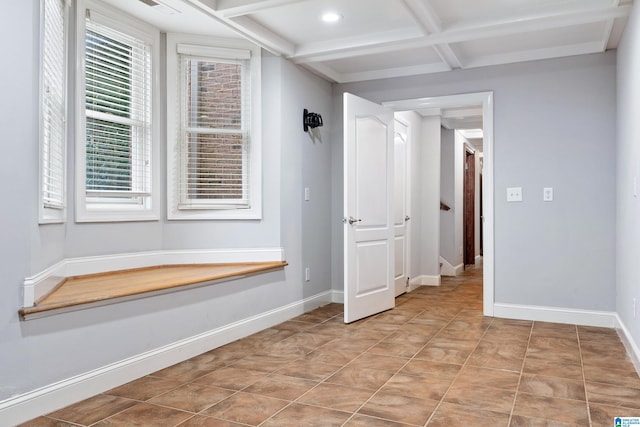 interior space with beamed ceiling, coffered ceiling, and light tile patterned floors