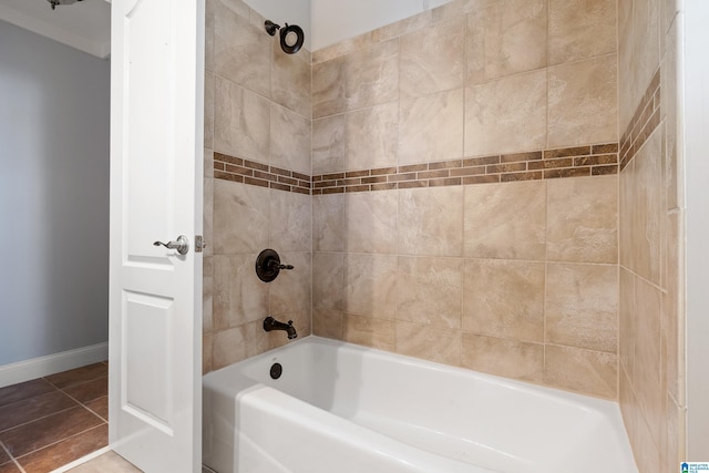 bathroom featuring tiled shower / bath combo and tile patterned flooring