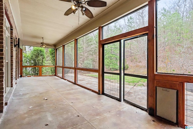 unfurnished sunroom with ceiling fan