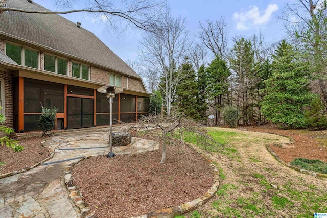 view of yard with a patio and a sunroom