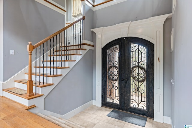 foyer featuring a high ceiling and french doors