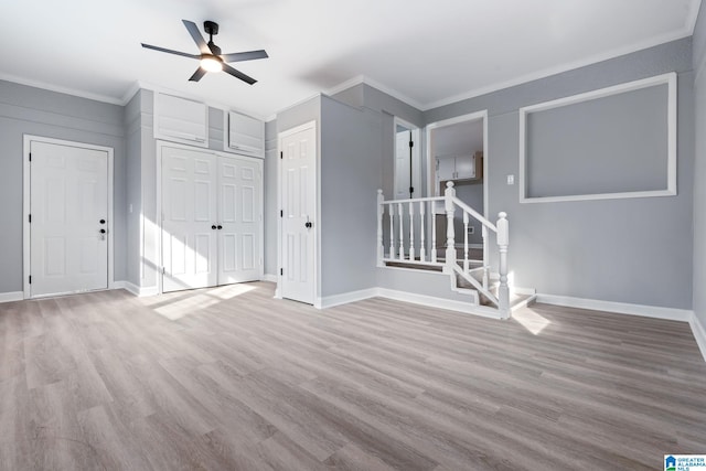 interior space with crown molding, ceiling fan, and light hardwood / wood-style flooring