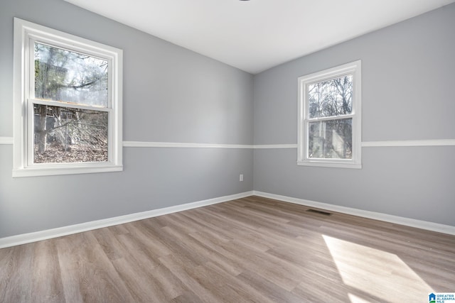 spare room with light hardwood / wood-style floors