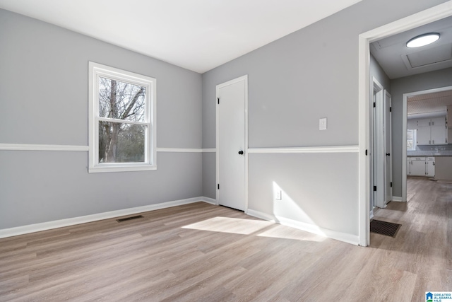 unfurnished room featuring light wood-type flooring