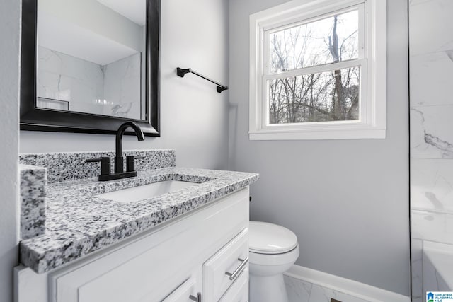 bathroom featuring vanity and toilet