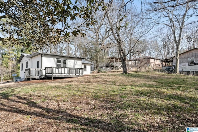 view of yard featuring a wooden deck and central air condition unit