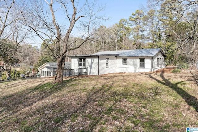 view of front facade featuring a front lawn and a deck