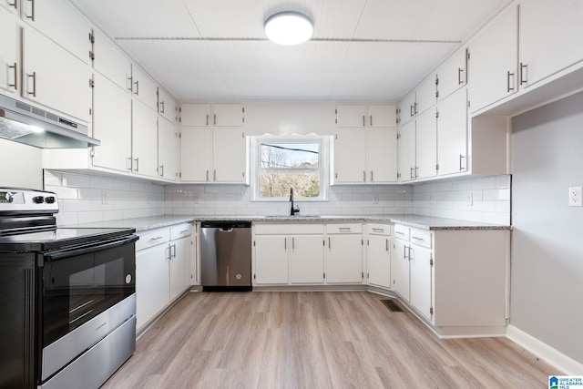 kitchen with stainless steel appliances, white cabinetry, sink, and light wood-type flooring