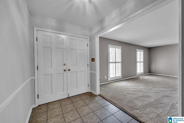 view of carpeted entrance foyer