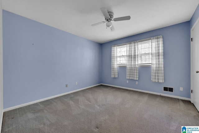 carpeted spare room with ceiling fan