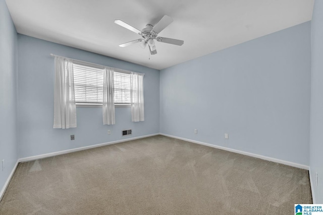 unfurnished room with light colored carpet and ceiling fan