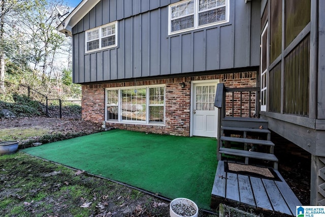 rear view of house featuring a yard