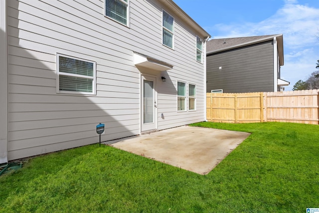 rear view of property featuring a patio and a lawn