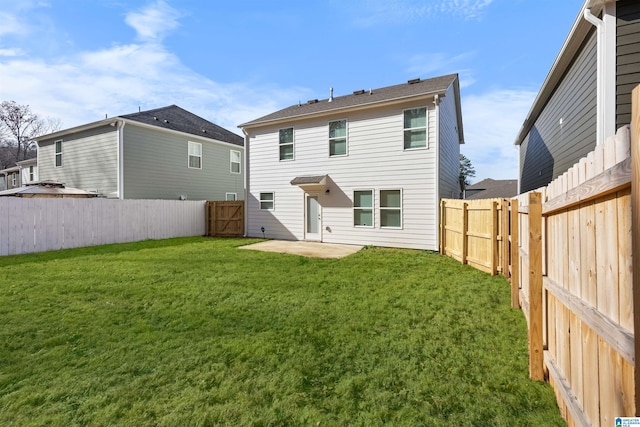 rear view of property with a yard and a patio area