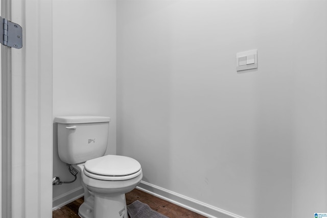 bathroom featuring wood-type flooring and toilet