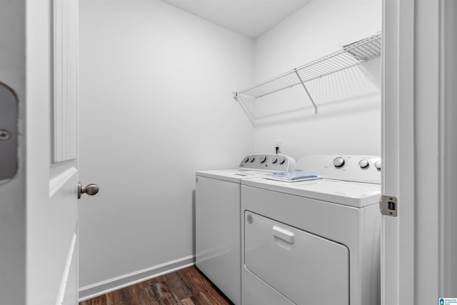 laundry area with dark hardwood / wood-style flooring and separate washer and dryer