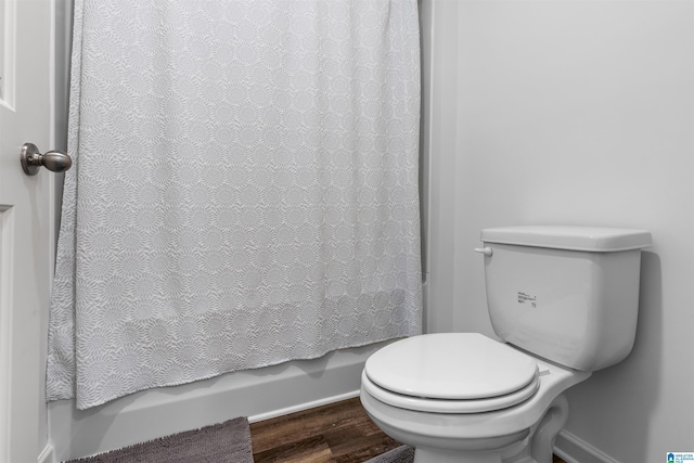 bathroom with walk in shower, wood-type flooring, and toilet