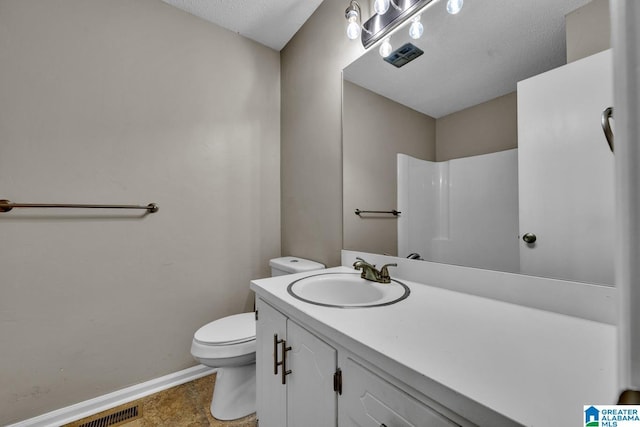 bathroom featuring walk in shower, vanity, toilet, and a textured ceiling