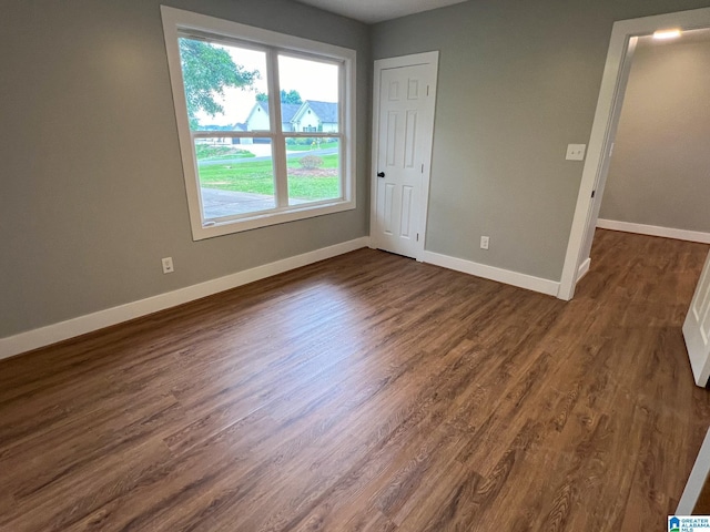 spare room with dark hardwood / wood-style flooring