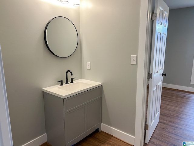 bathroom featuring hardwood / wood-style flooring and vanity