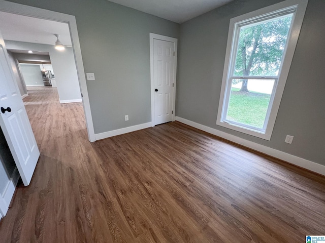 unfurnished bedroom featuring dark wood-type flooring