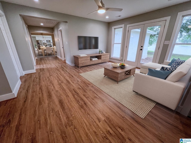 living room featuring hardwood / wood-style floors, french doors, and ceiling fan