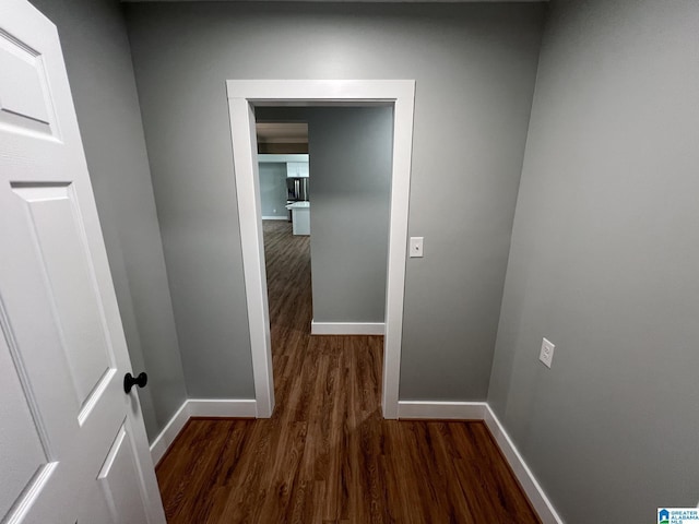 hall with dark wood-type flooring