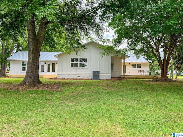 back of house with a yard and cooling unit