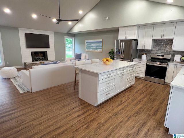 kitchen with stainless steel appliances, a center island, and white cabinets