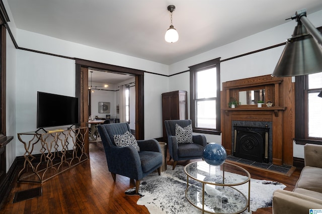 living room featuring dark wood-type flooring and a fireplace