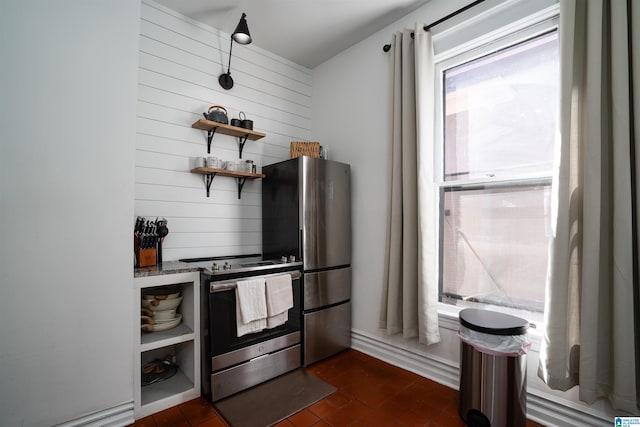 kitchen with stainless steel appliances and wooden walls