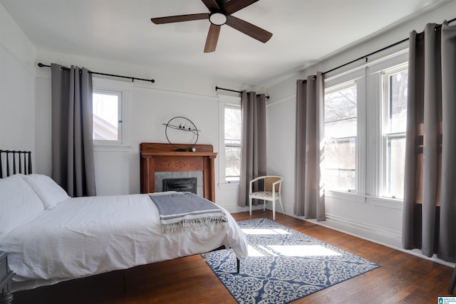 bedroom with ceiling fan and dark hardwood / wood-style flooring