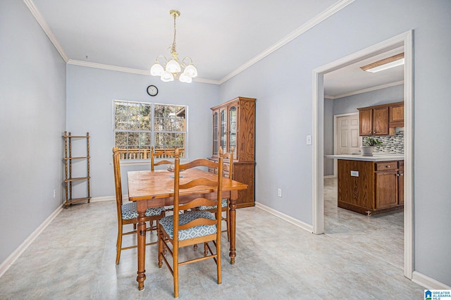 dining space with ornamental molding and a chandelier