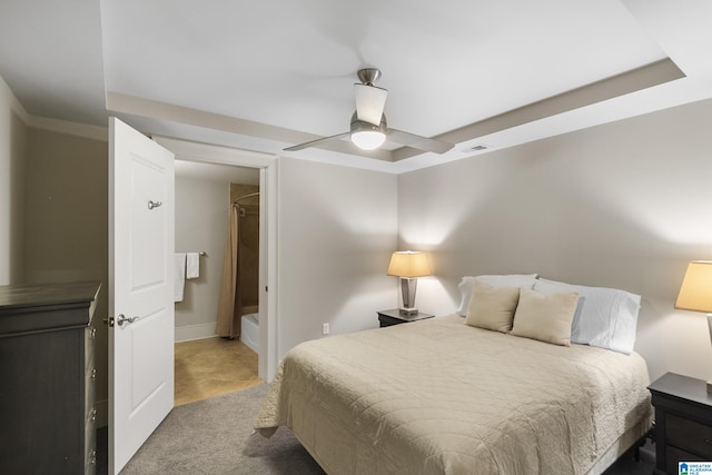 bedroom featuring a raised ceiling, carpet floors, and ceiling fan