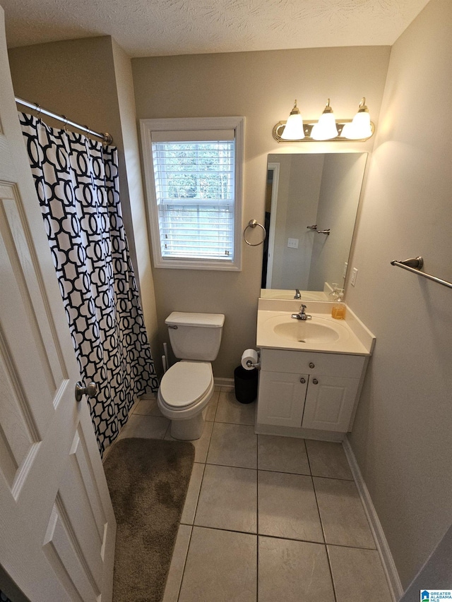 bathroom with vanity, tile patterned floors, a textured ceiling, and toilet