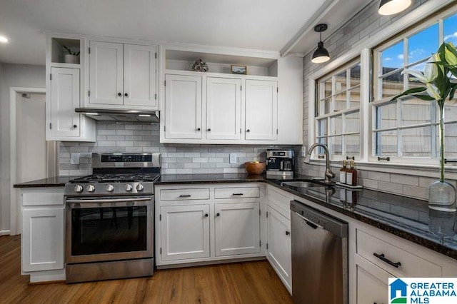 kitchen with white cabinetry, appliances with stainless steel finishes, and hanging light fixtures