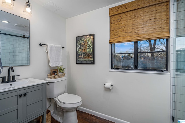 bathroom featuring vanity, hardwood / wood-style flooring, a shower with shower door, and toilet