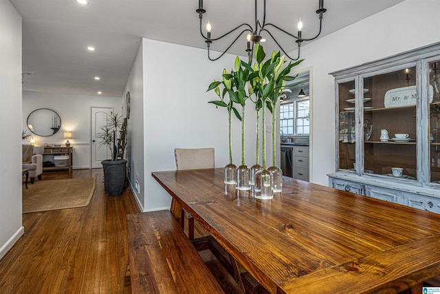 dining area featuring an inviting chandelier and dark hardwood / wood-style flooring