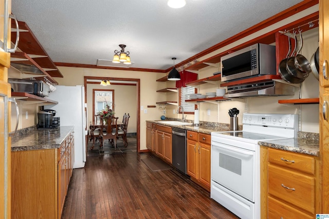 kitchen featuring dark wood-type flooring, sink, crown molding, stainless steel appliances, and range hood