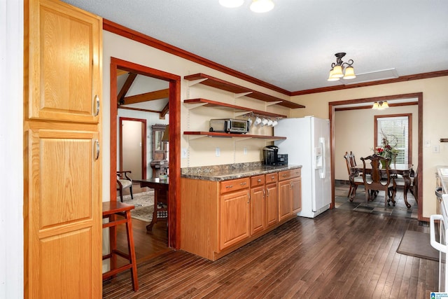 kitchen with an inviting chandelier, dark wood-type flooring, ornamental molding, and white fridge with ice dispenser