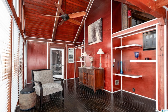 living area with wood walls, wood-type flooring, ceiling fan, wood ceiling, and beam ceiling