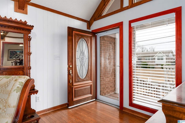 entrance foyer with vaulted ceiling with beams and hardwood / wood-style flooring